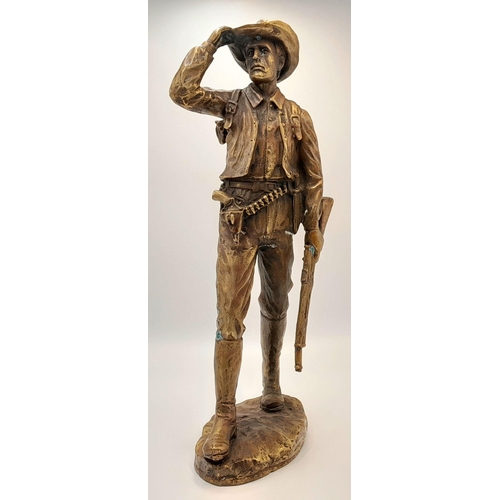 2109 - A 20th Century Figure of a Faux Bronze Cowboy Looking to the Distance. 47cm tall.