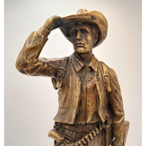 2109 - A 20th Century Figure of a Faux Bronze Cowboy Looking to the Distance. 47cm tall.