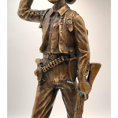 2109 - A 20th Century Figure of a Faux Bronze Cowboy Looking to the Distance. 47cm tall.