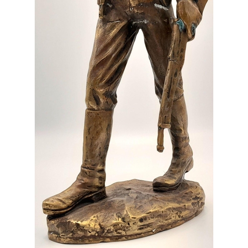 2109 - A 20th Century Figure of a Faux Bronze Cowboy Looking to the Distance. 47cm tall.