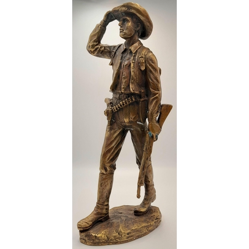 2109 - A 20th Century Figure of a Faux Bronze Cowboy Looking to the Distance. 47cm tall.