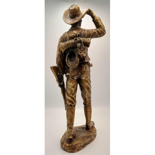 2109 - A 20th Century Figure of a Faux Bronze Cowboy Looking to the Distance. 47cm tall.