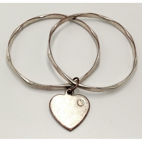 1988 - A fashion white metal double bangle with Heart charm. Diameter 7.5cm.