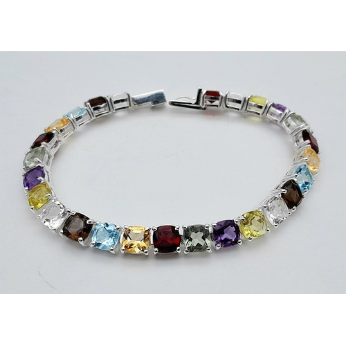 2006 - An Amethyst, Garnet, Citrine and Blue Topaz Tennis Bracelet. Set in 925 Silver. 17cm. Cd-1603