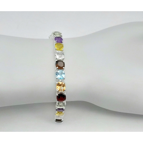 2006 - An Amethyst, Garnet, Citrine and Blue Topaz Tennis Bracelet. Set in 925 Silver. 17cm. Cd-1603