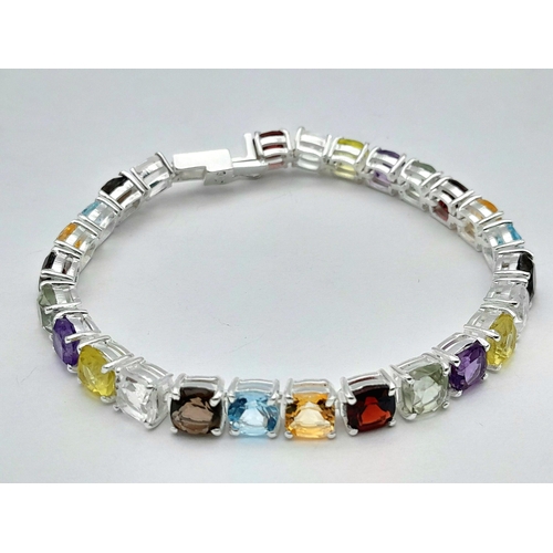 2006 - An Amethyst, Garnet, Citrine and Blue Topaz Tennis Bracelet. Set in 925 Silver. 17cm. Cd-1603