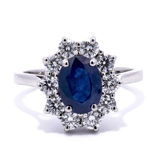 2209 - A Platinum Cluster Ring - featuring a 1.29ct oval cut sapphire with a 0.74ctw round cut diamond surr... 