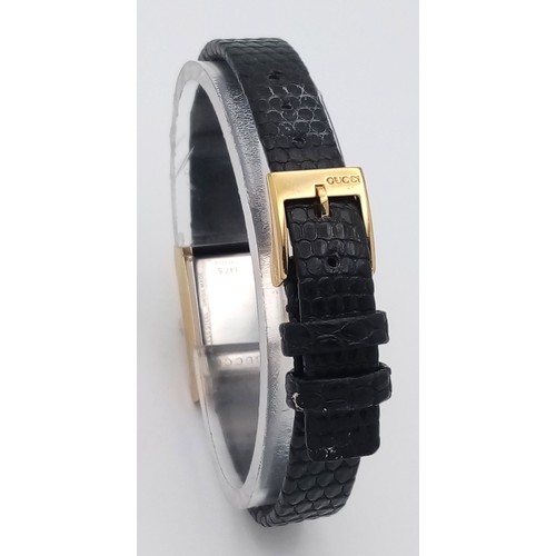 564 - A Gucci gold plated ladies quartz wristwatch with black leather strap, 14mm case diameter, in good w... 