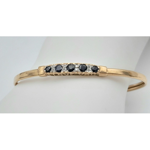 12 - A Fancy 9K Yellow Gold Sapphire and Diamond Bangle. Decorative 'I Love You Always' Message. 6.5cm in... 