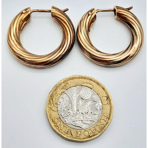 142 - A Pair of 9K Gold Hoop Earrings. Ridged swirl pattern. 2.5cm.
5g.