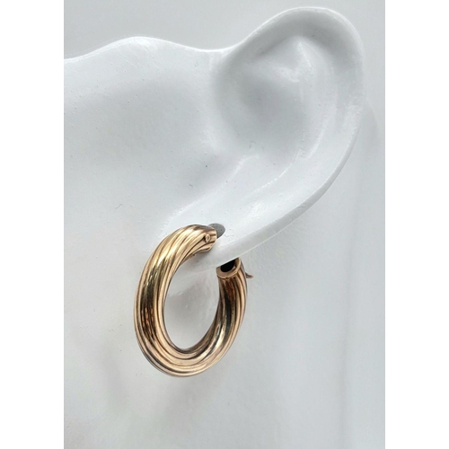 142 - A Pair of 9K Gold Hoop Earrings. Ridged swirl pattern. 2.5cm.
5g.