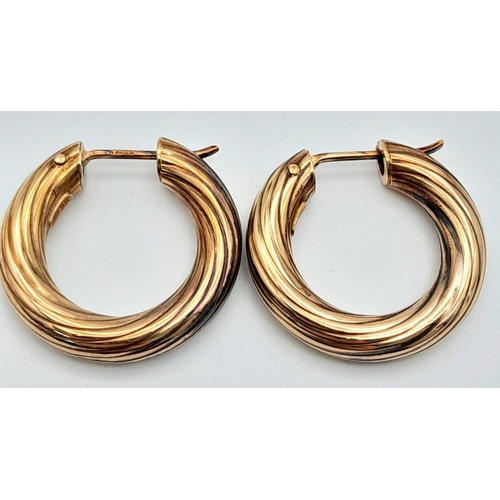 142 - A Pair of 9K Gold Hoop Earrings. Ridged swirl pattern. 2.5cm.
5g.