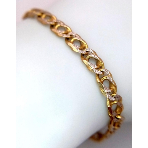 22 - An Italian 9K Yellow and White Gold Fancy Curb Bracelet. 
18cm. 6.05g.