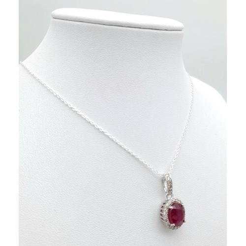 42 - A 3.75ct Oval Cut Ruby Pendant with Diamond Accents. Set in 925 Silver. Diamonds approx 0.50ctw. Com... 