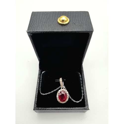 42 - A 3.75ct Oval Cut Ruby Pendant with Diamond Accents. Set in 925 Silver. Diamonds approx 0.50ctw. Com... 