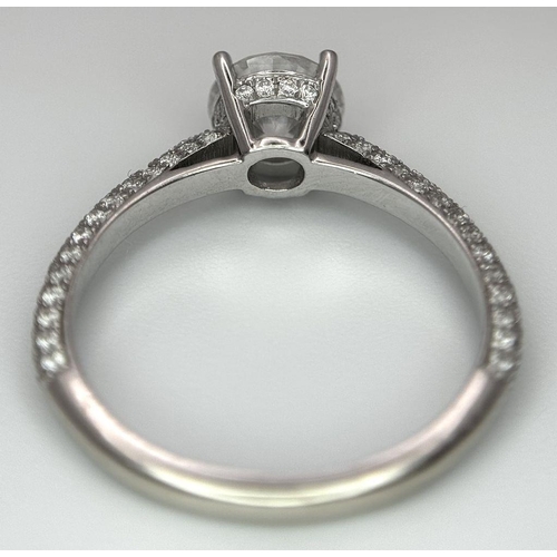 43 - An 18K White Gold Diamond Ring. Brilliant round cut 1ct diamond with a further 0.5ctw of diamonds on... 