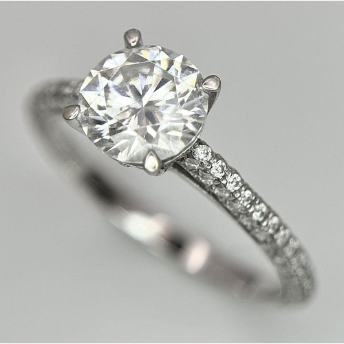 43 - An 18K White Gold Diamond Ring. Brilliant round cut 1ct diamond with a further 0.5ctw of diamonds on... 