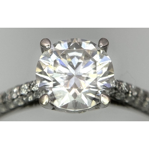 43 - An 18K White Gold Diamond Ring. Brilliant round cut 1ct diamond with a further 0.5ctw of diamonds on... 