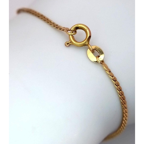 57 - An 18K Yellow Gold Scale Link Flat Bracelet. 19cm. Charm attachment. 2.4g.