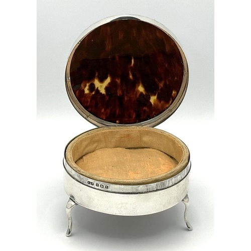 79 - An Antique Sterling Silver and Tortoiseshell Trinket Box. Circular form with scrolled edge. Soft tex... 