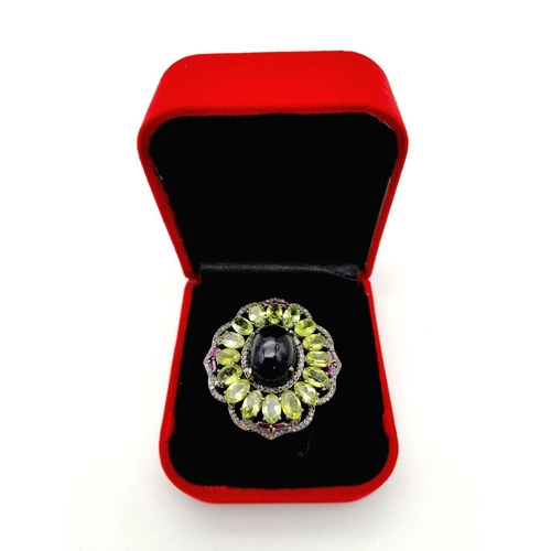 917 - A Peridot, Opal, Ruby and Diamond Ring. Set in 925 silver. Central black opal cabochon with peridot ... 