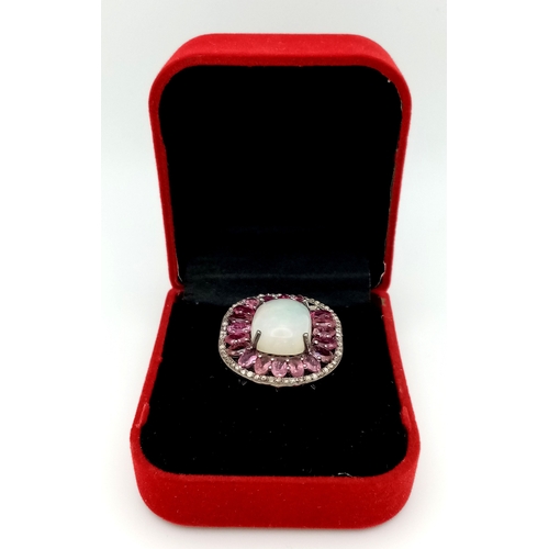 848 - A 925 sterling silver ring featuring a central opal stone surrounded by pink tourmaline stones. Ring... 
