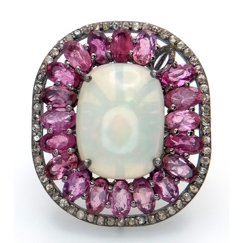 848 - A 925 sterling silver ring featuring a central opal stone surrounded by pink tourmaline stones. Ring... 
