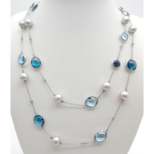 545 - An 18K White Gold, Pearl, Diamond and Topaz Matinee Length Necklace. 82cm.33.5g total weight.