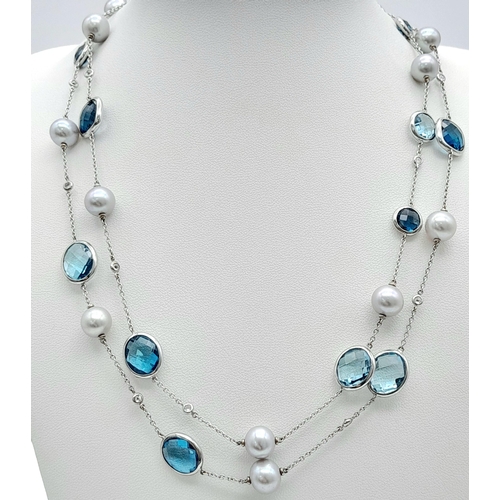 545 - An 18K White Gold, Pearl, Diamond and Topaz Matinee Length Necklace. 82cm.33.5g total weight.