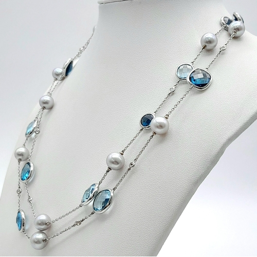 545 - An 18K White Gold, Pearl, Diamond and Topaz Matinee Length Necklace. 82cm.33.5g total weight.