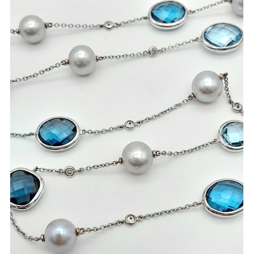 545 - An 18K White Gold, Pearl, Diamond and Topaz Matinee Length Necklace. 82cm.33.5g total weight.