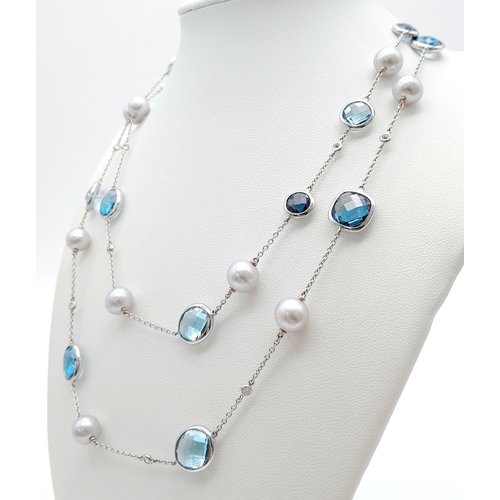 545 - An 18K White Gold, Pearl, Diamond and Topaz Matinee Length Necklace. 82cm.33.5g total weight.