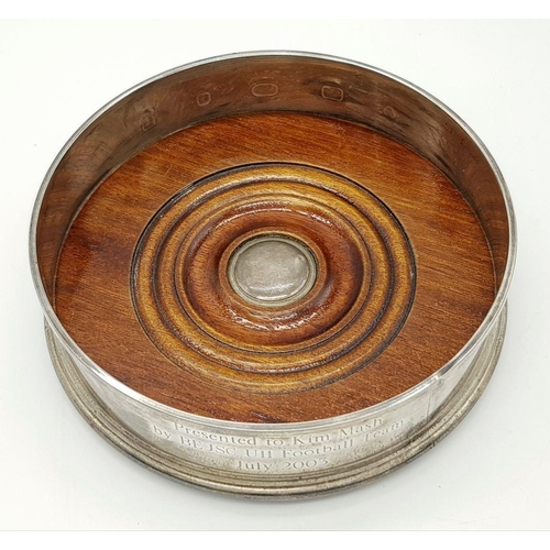 491 - A 925 sterling silver wine coaster featuring wooden detail and a felt-lined base. Engraved with 