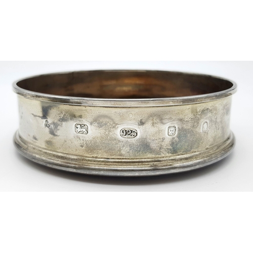 491 - A 925 sterling silver wine coaster featuring wooden detail and a felt-lined base. Engraved with 