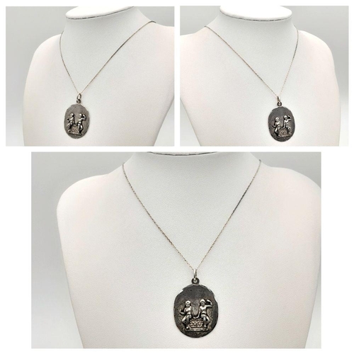 903 - A vintage Sterling Silver Cherubic Ornate Pendant with Sterling Silver Necklace. 50 and 4cm. 7.5g