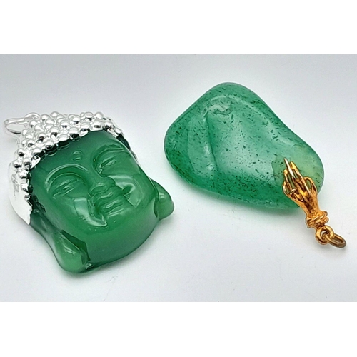 951 - A pair of green stone pendants, one featuring a Buddha motif, and the other with a smooth pebble-lik... 