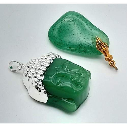 951 - A pair of green stone pendants, one featuring a Buddha motif, and the other with a smooth pebble-lik... 