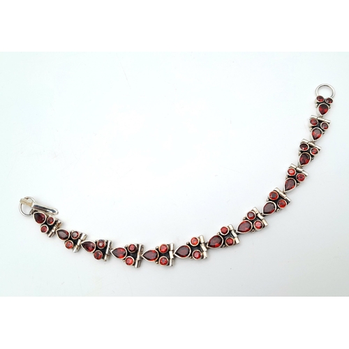 126 - A Vintage Sterling Silver Garnet Set Tennis Bracelet-18.5cm Length. Set with Pear and Round Cut Garn... 