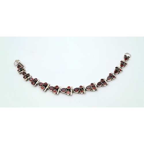 126 - A Vintage Sterling Silver Garnet Set Tennis Bracelet-18.5cm Length. Set with Pear and Round Cut Garn... 