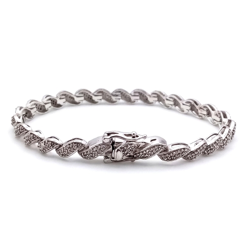 14 - A Hallmarked Sterling Silver Diamond Set Tennis Bracelet 19.5cm Length. Set with a profusion of roun... 