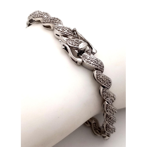 14 - A Hallmarked Sterling Silver Diamond Set Tennis Bracelet 19.5cm Length. Set with a profusion of roun... 