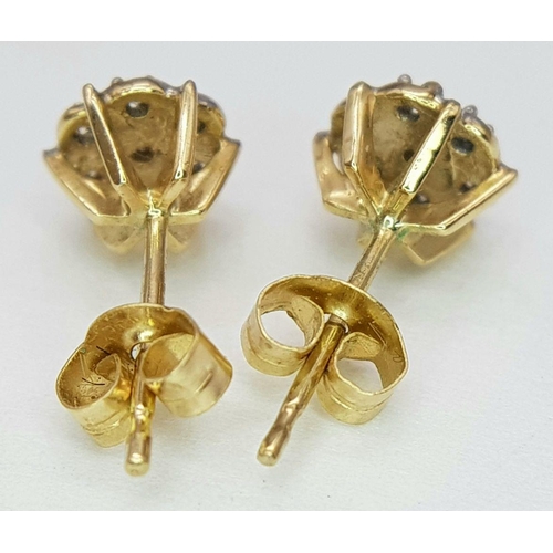 77 - A Pair of 9 Carat Yellow Gold Diamond Set Cluster Earrings. Each Earring is set with Seven Round Cut... 