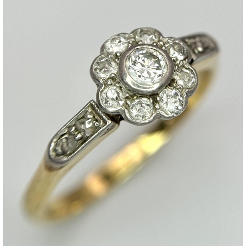 25 - An 18K Yellow Gold, Platinum and Diamond Ring. 0.75ctw of diamonds in floral form. Size Q 1/2. 3.5g ... 