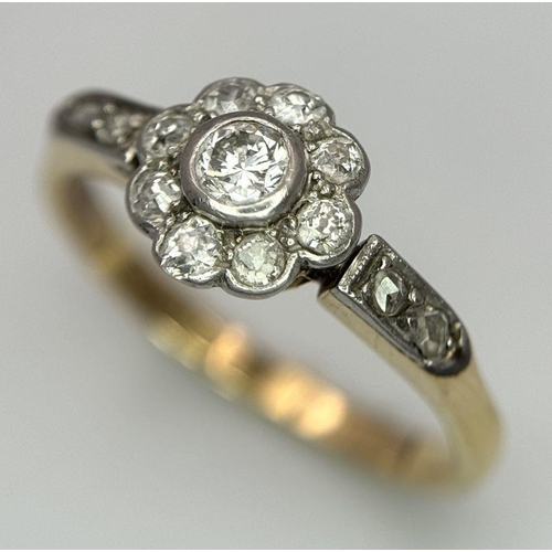 25 - An 18K Yellow Gold, Platinum and Diamond Ring. 0.75ctw of diamonds in floral form. Size Q 1/2. 3.5g ... 