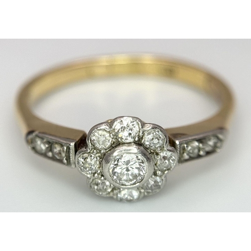 25 - An 18K Yellow Gold, Platinum and Diamond Ring. 0.75ctw of diamonds in floral form. Size Q 1/2. 3.5g ... 