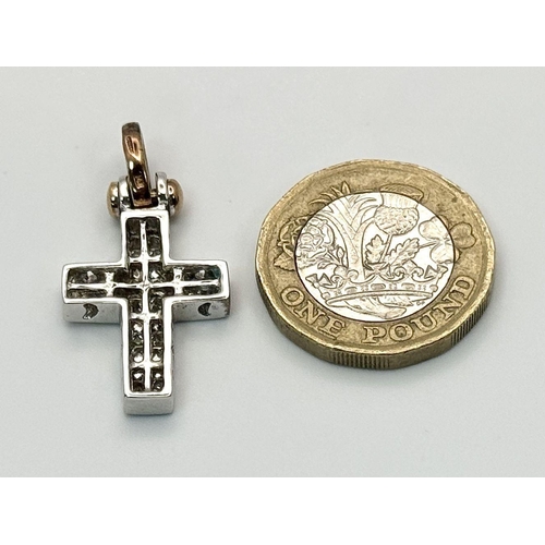 319 - A 14K White Gold Pave Diamond Cross Pendant. Yellow gold bail. 3cm x 1.5cm. 4.9g total weight.  Ref:... 