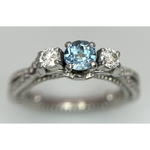 55 - AN 18K WHITE GOLD DIAMOND & TOPAZ 3 STONE RING. 5.8G. SIZE H 1/2.