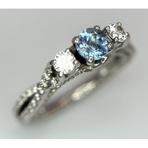 55 - AN 18K WHITE GOLD DIAMOND & TOPAZ 3 STONE RING. 5.8G. SIZE H 1/2.