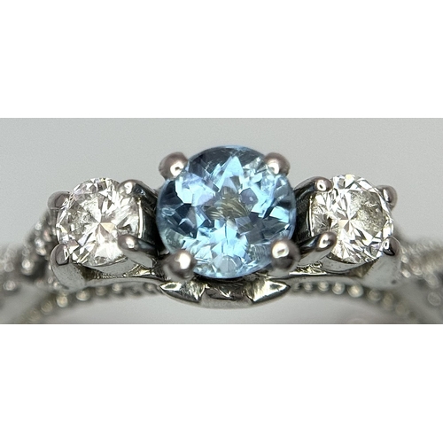 55 - AN 18K WHITE GOLD DIAMOND & TOPAZ 3 STONE RING. 5.8G. SIZE H 1/2.