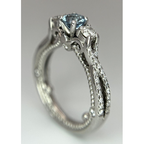 55 - AN 18K WHITE GOLD DIAMOND & TOPAZ 3 STONE RING. 5.8G. SIZE H 1/2.